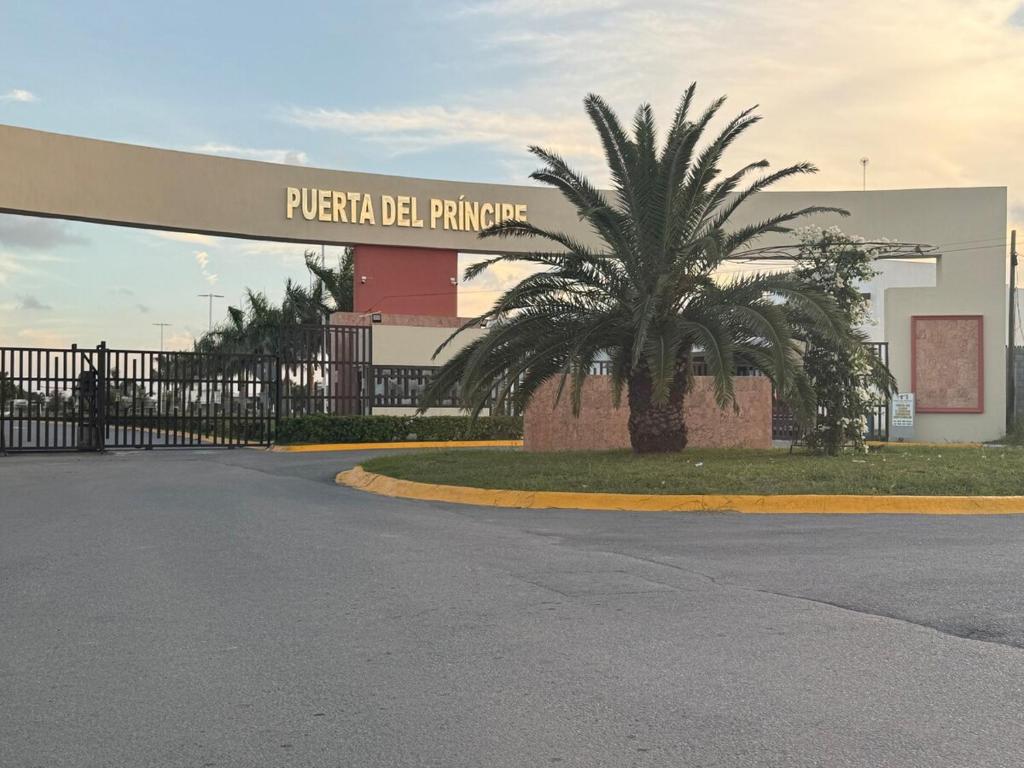 a building with a palm tree in front of a building at Discreet luxury in an exclusive area in Matamoros
