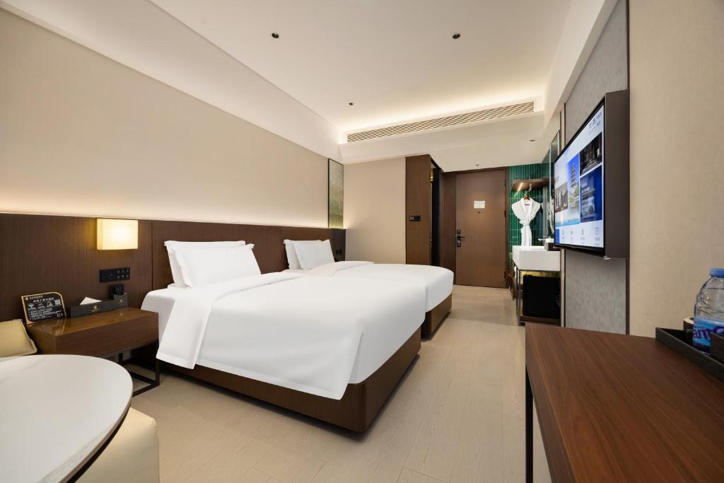 Postel nebo postele na pokoji v ubytování Beijing Suiyu Hotel