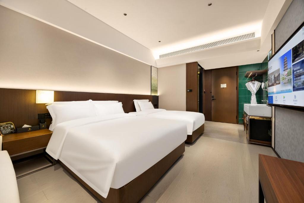 Postel nebo postele na pokoji v ubytování Beijing Suiyu Hotel