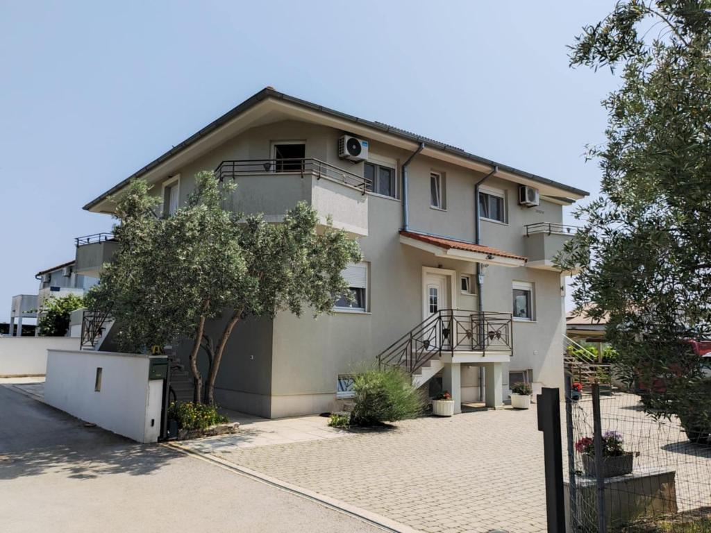 a large white building with a balcony at Apartment Lighthouse n3 in Fažana