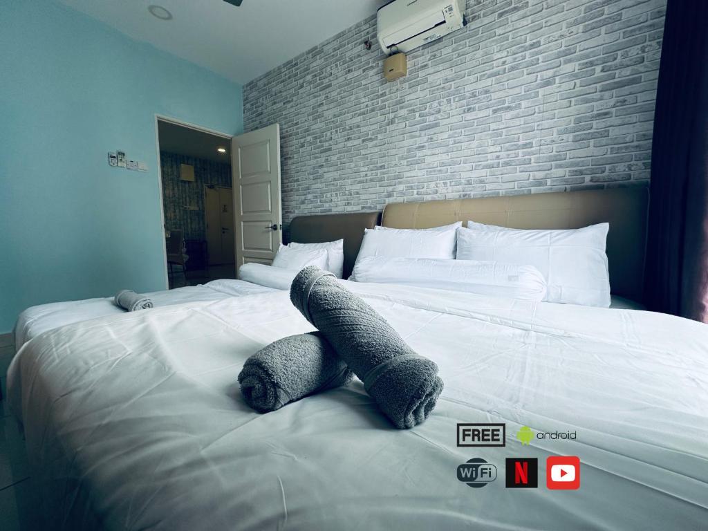 a bed with a teddy bear laying on it at 12pax 3-Bedroom l Seaview l Georgetown l Gleneagles l Mansion One in George Town