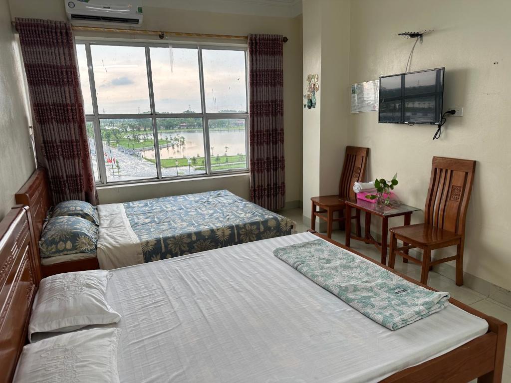 Postel nebo postele na pokoji v ubytování Nhà nghỉ 19 Đền Trần