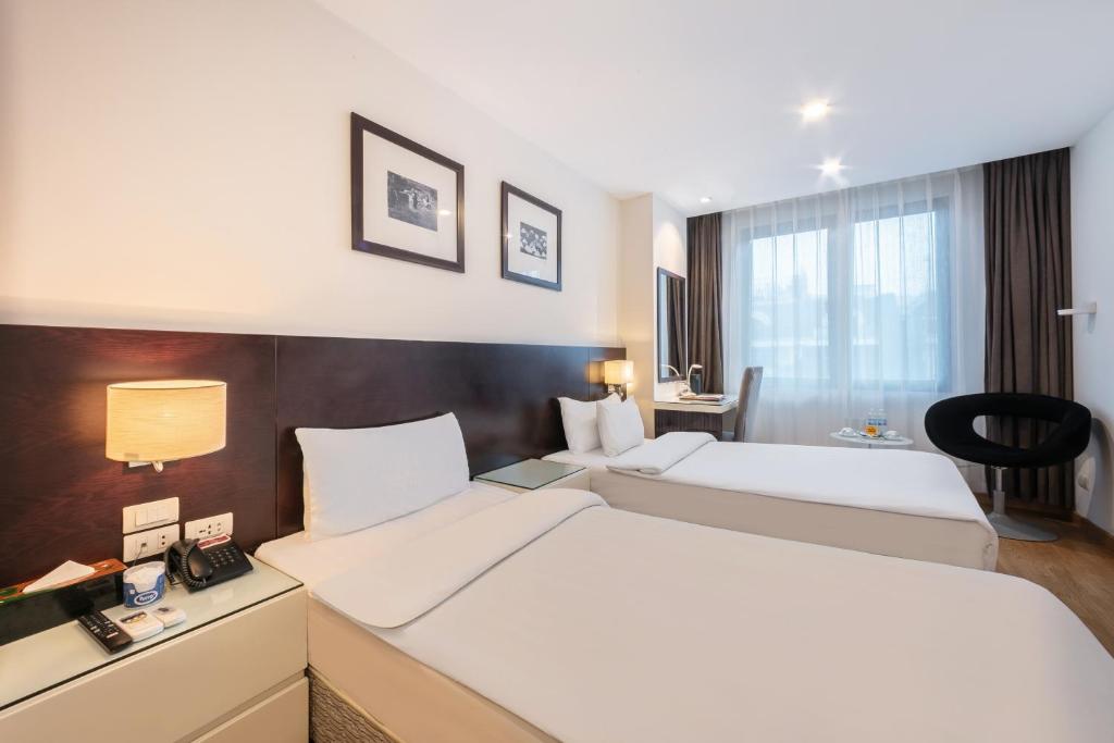 Postel nebo postele na pokoji v ubytování A25 Hotel - 66 Trần Thái Tông