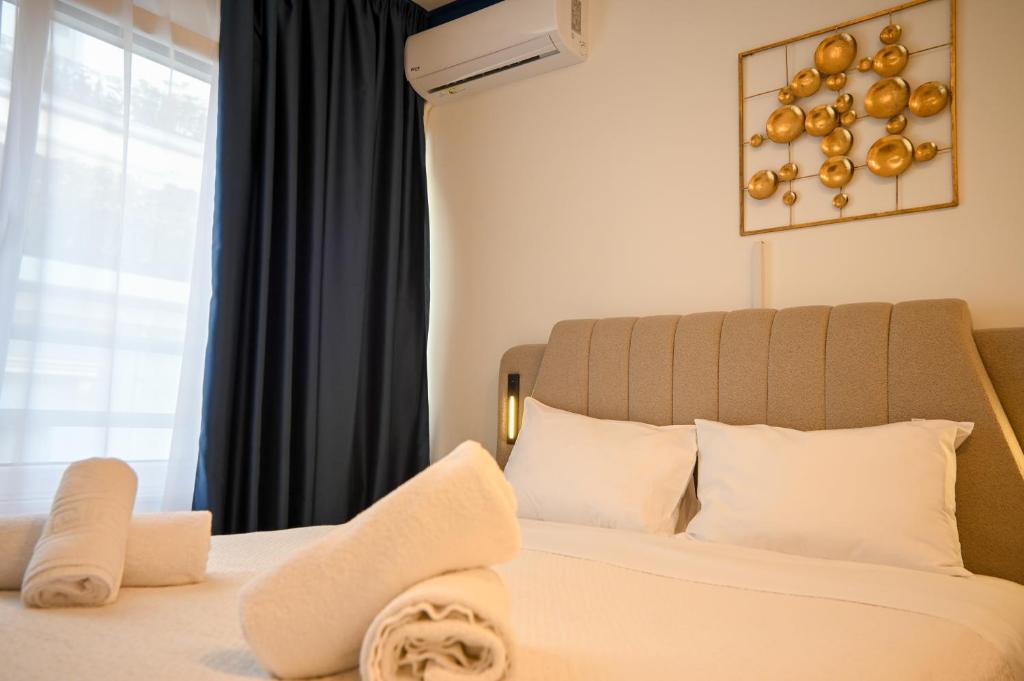 a bedroom with a white bed with a window at Syntagma Plaka Suite by Zeussuites in Athens