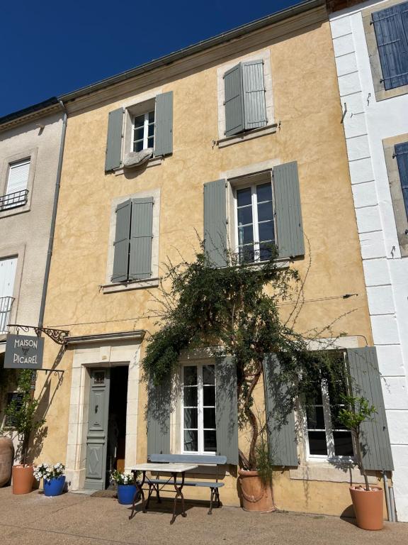 a building with a bench in front of it at Maison Picarel, Chambres d'Hôtes, Leucate in Leucate