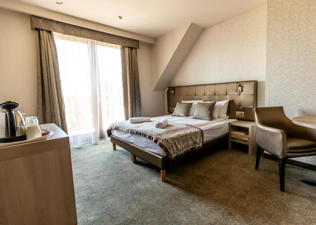 Postel nebo postele na pokoji v ubytování Mirage Hotel Sárvár