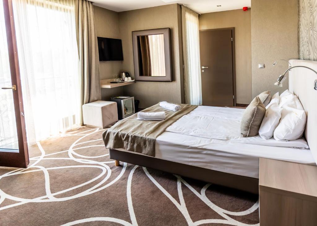 Postel nebo postele na pokoji v ubytování Mirage Hotel Sárvár