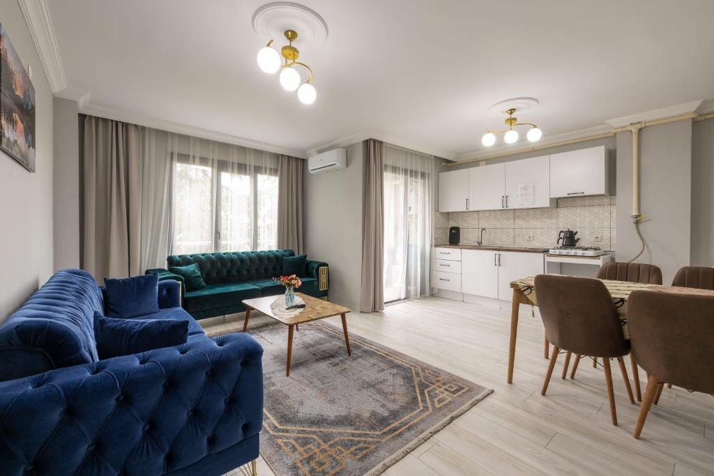 a living room with a blue couch and a table at LOYA HOME CiTY CENTeR in Trabzon