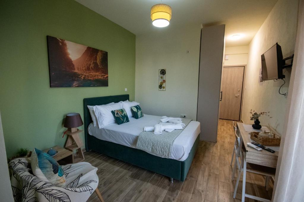 a bedroom with a bed and a chair in a room at vagia's studio in Alexandroupoli