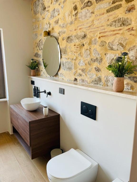a bathroom with a white toilet and a sink at Le Boulevard Suites & Apartments in Olbia