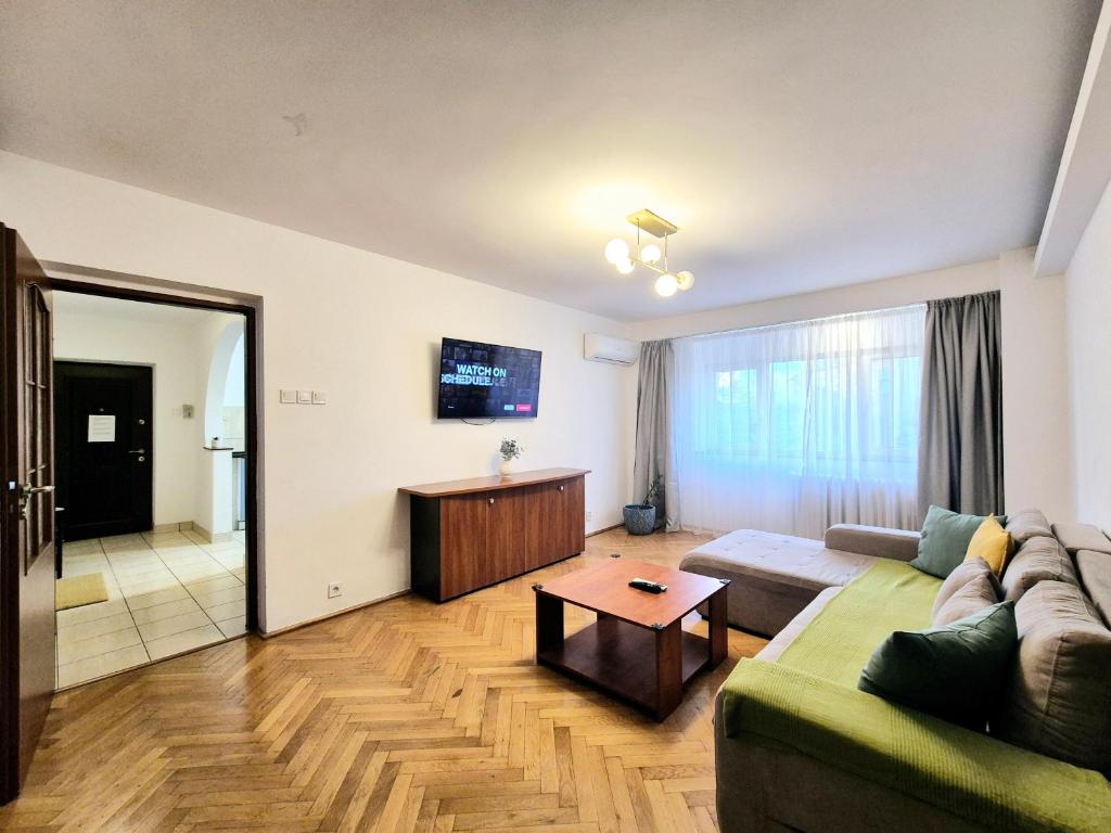 a living room with a couch and a table at TRANQUIL Unirii - Airy & Comfy with Parking - Next 2Parliament in Bucharest