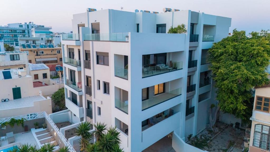 an apartment building with balconies in a city at D&R Boutique Apartments Central in Rhodes Town