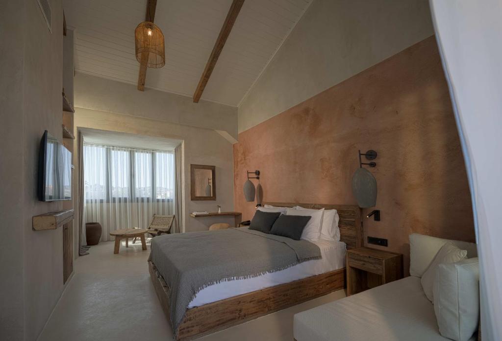 a bedroom with a bed and a television in it at Wakana Alaçatı in Alacati