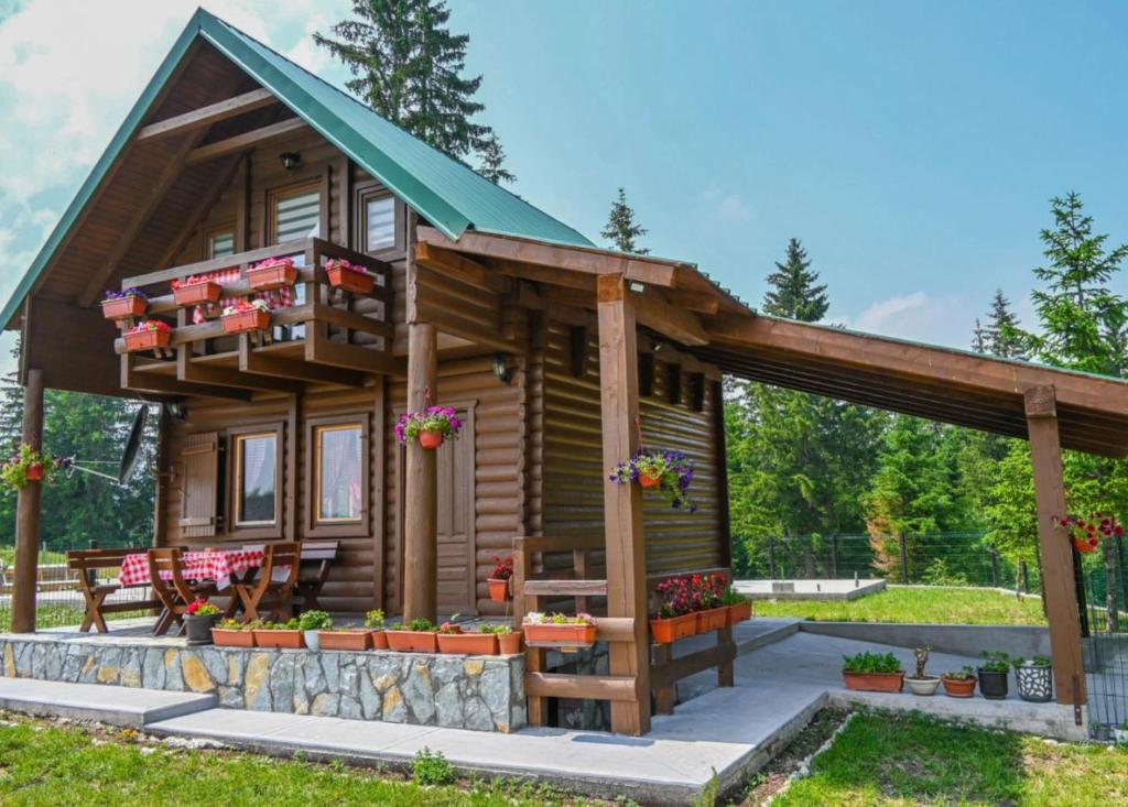 a log cabin with a porch and a balcony at Mountain Viewpoint in Žabljak