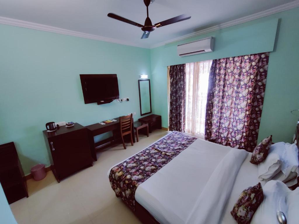 Postel nebo postele na pokoji v ubytování Hotel Goan Heritage