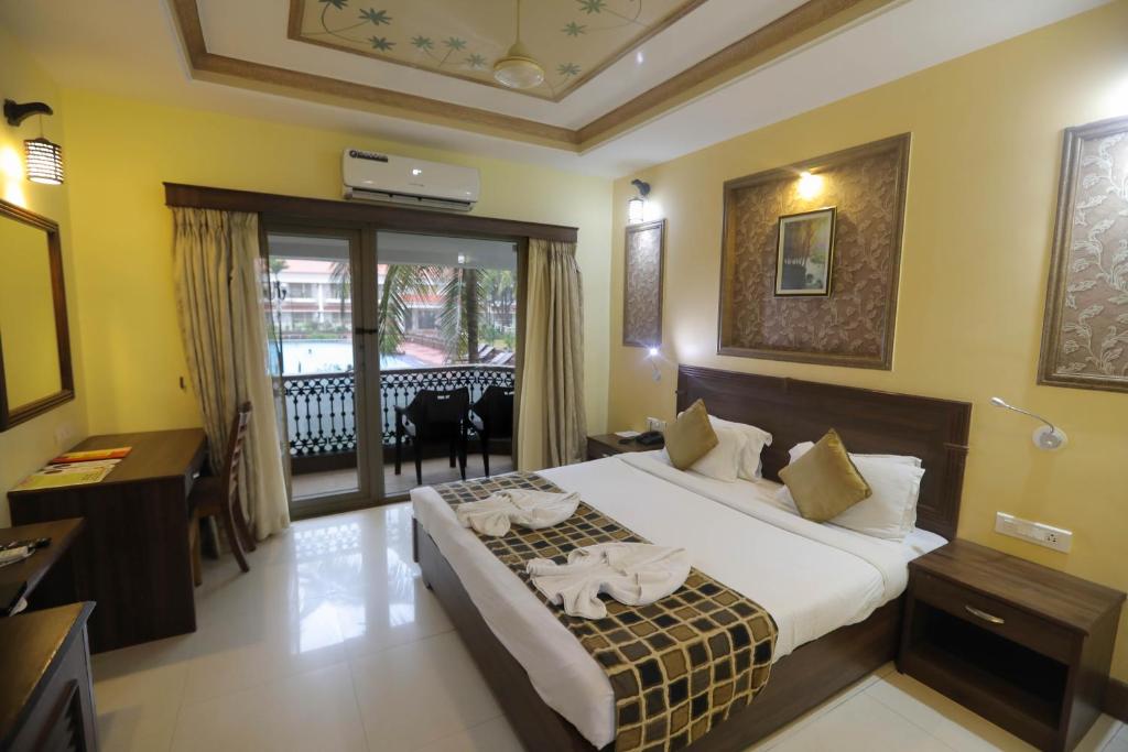 Postel nebo postele na pokoji v ubytování Hotel Goan Heritage