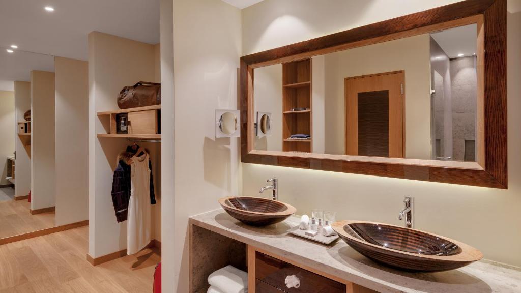 
a bathroom with a sink and a mirror at Hotel Alte Post Bonaduz in Bonaduz
