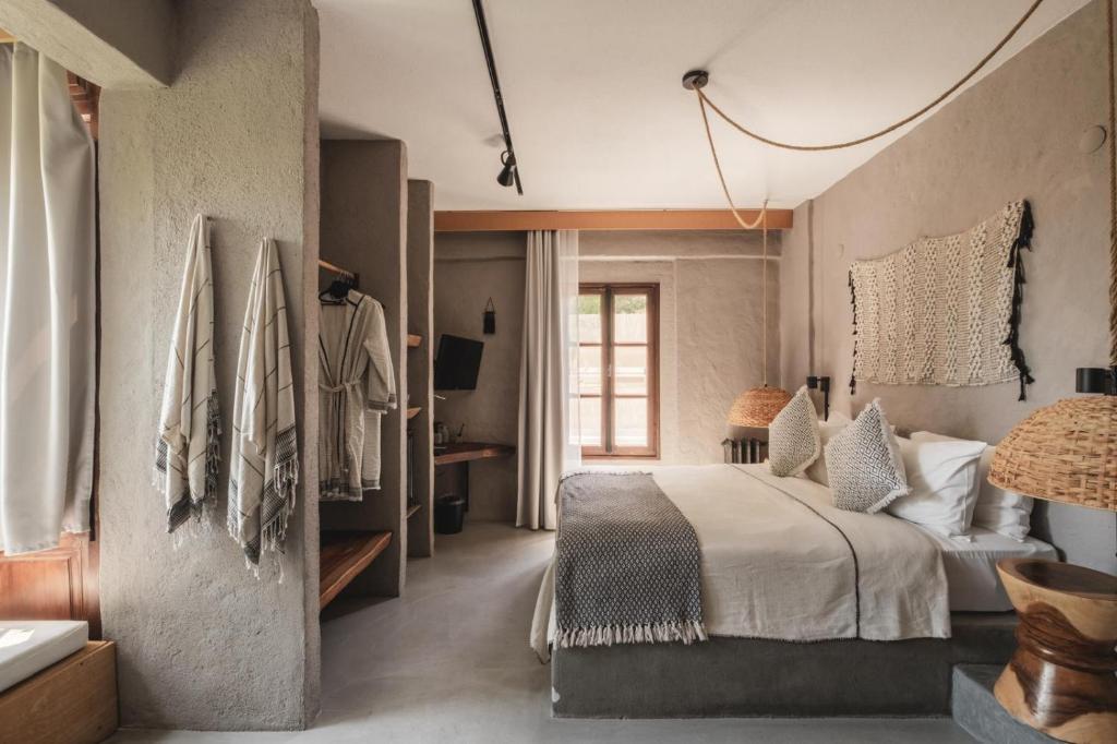 a bedroom with a large bed in a room at GAIA ALAÇATI in Alaçatı