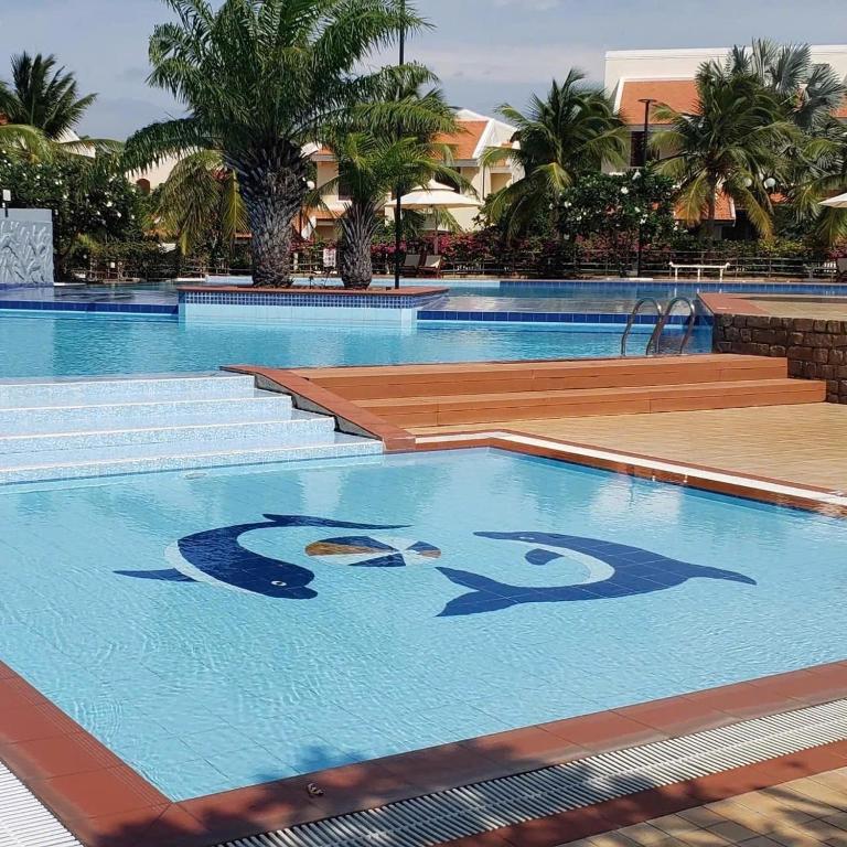 a swimming pool with a painting of a woman on it at Biệt Thự C19 Mũi Né Domaine in Ấp Chợ Dinh