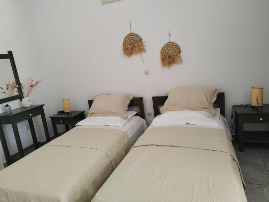 two beds sitting next to each other in a room at Marathos in Kanakis
