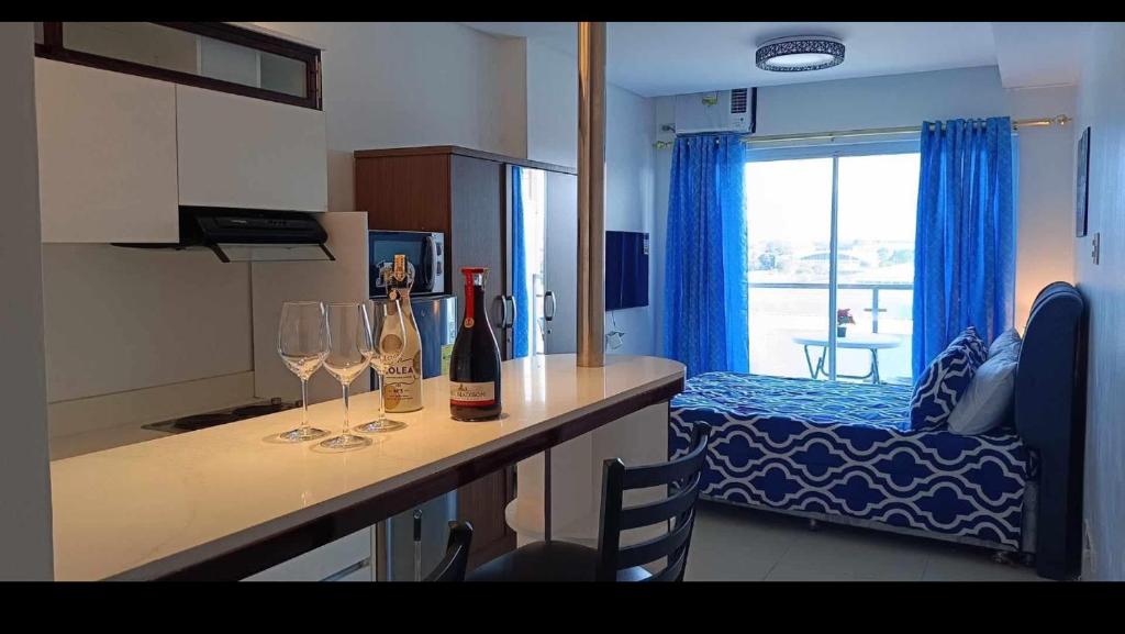 a kitchen with two glasses of wine on a counter at Primavera Cozy studio Condominium, Cagayan de Oro City, Philippines in Cagayan de Oro