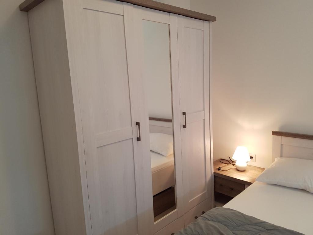 a bedroom with a large white cabinet next to a bed at Apartments Tereza in Senj