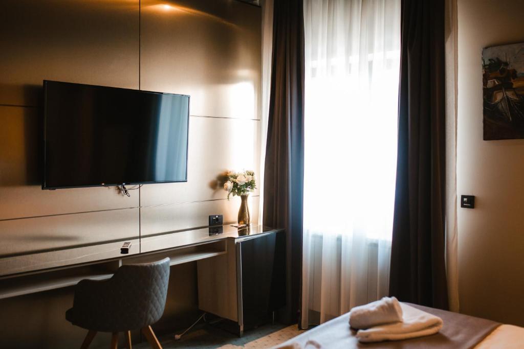 TV a/nebo společenská místnost v ubytování Garni Uni Elita Lux Hotel