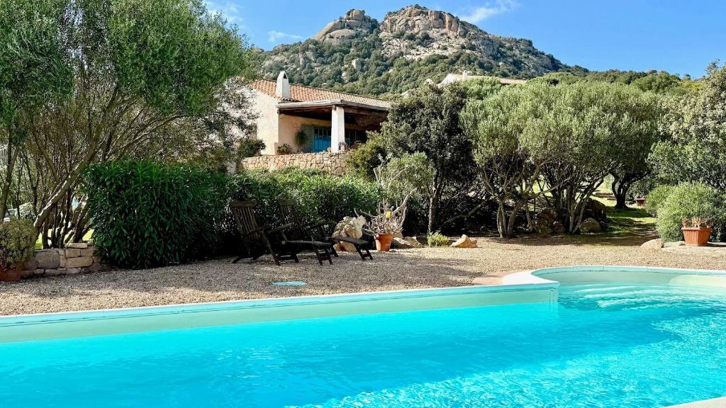 a house with a swimming pool in front of a house at Stazzu La Sarra in Cannigione