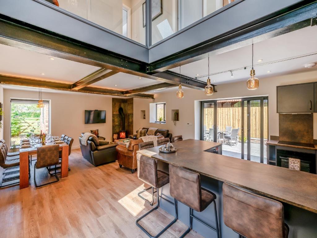 an open kitchen and living room with a large table and chairs at The Warren - Uk42858 in Rise