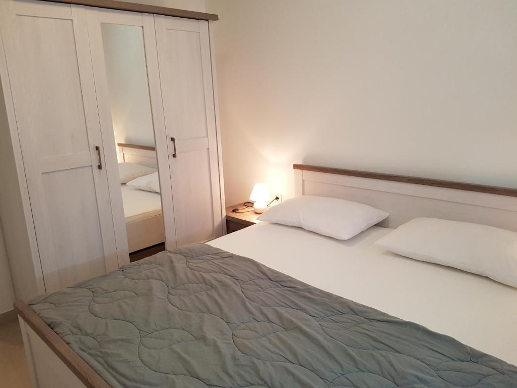 a small bedroom with a bed and a closet at Apartments Tereza in Senj