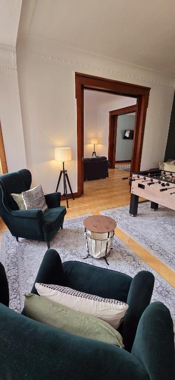 a living room with a blue couch and a table at 3BR - Bremerhaven Apartment in Bremerhaven