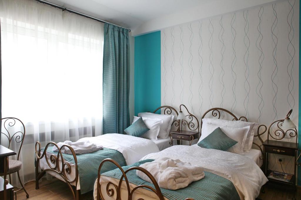 Ένα ή περισσότερα κρεβάτια σε δωμάτιο στο Hotel DUM