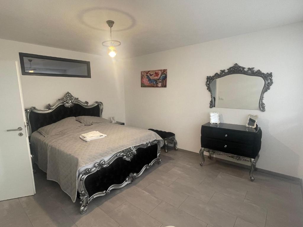 a bedroom with a bed and a mirror on the wall at Auszeit am Ipf in Bopfingen