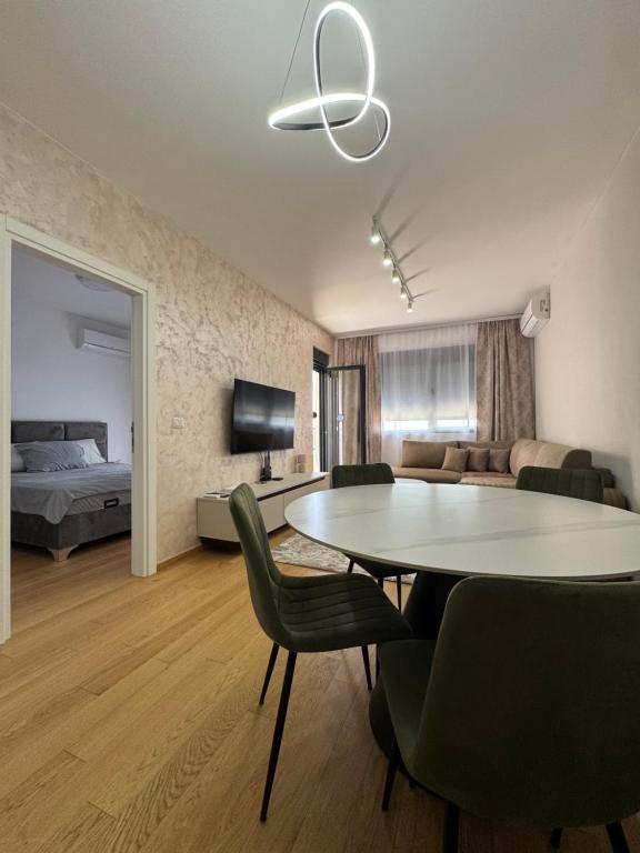 ベチチにあるLalur apartment Bečićiのテーブルと椅子とベッドのあるリビングルーム