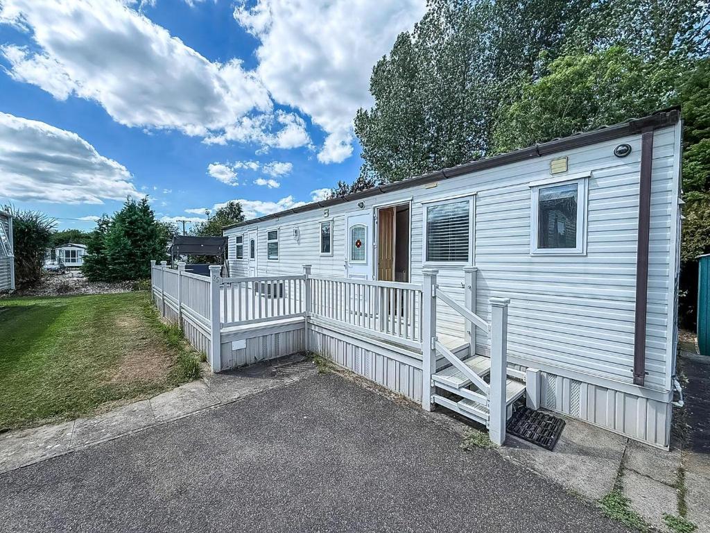 a white mobile home with a white fence at Great Caravan With Spacious Decking Southview Holiday Park, Skegness Ref 33035V in Skegness