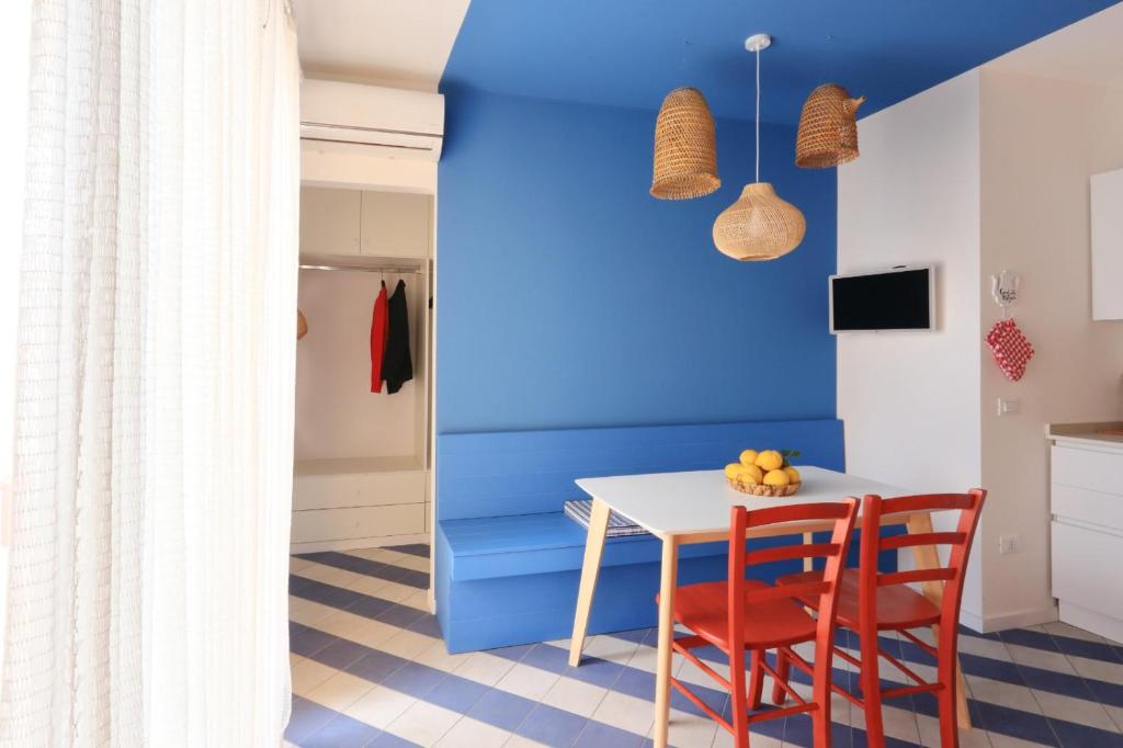 a dining room with blue walls and a table and chairs at A' Terrazza in Santa Flavia