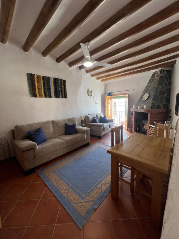 a living room with a couch and a table at Casa Estrella de la Alpujarra in Almegíjar