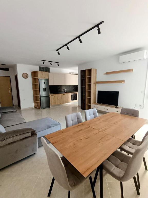 a living room with a wooden table and chairs at Old Beach Apartments 2 in Vlorë