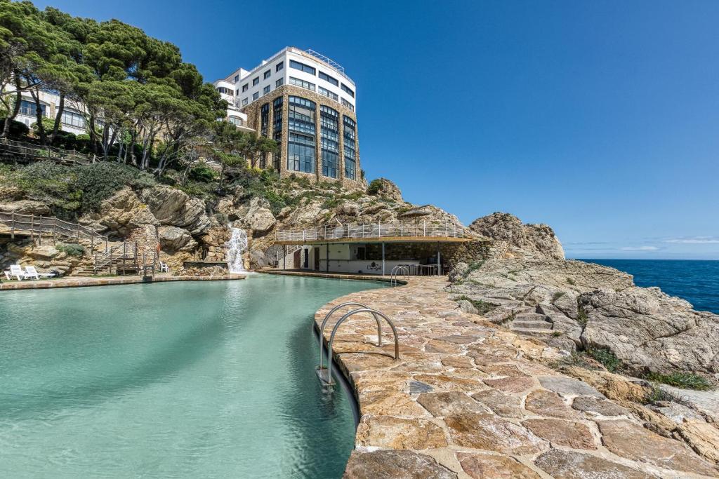 a pool of water in front of a building at Exclusivo Loft En Cap Sa Sal in Begur