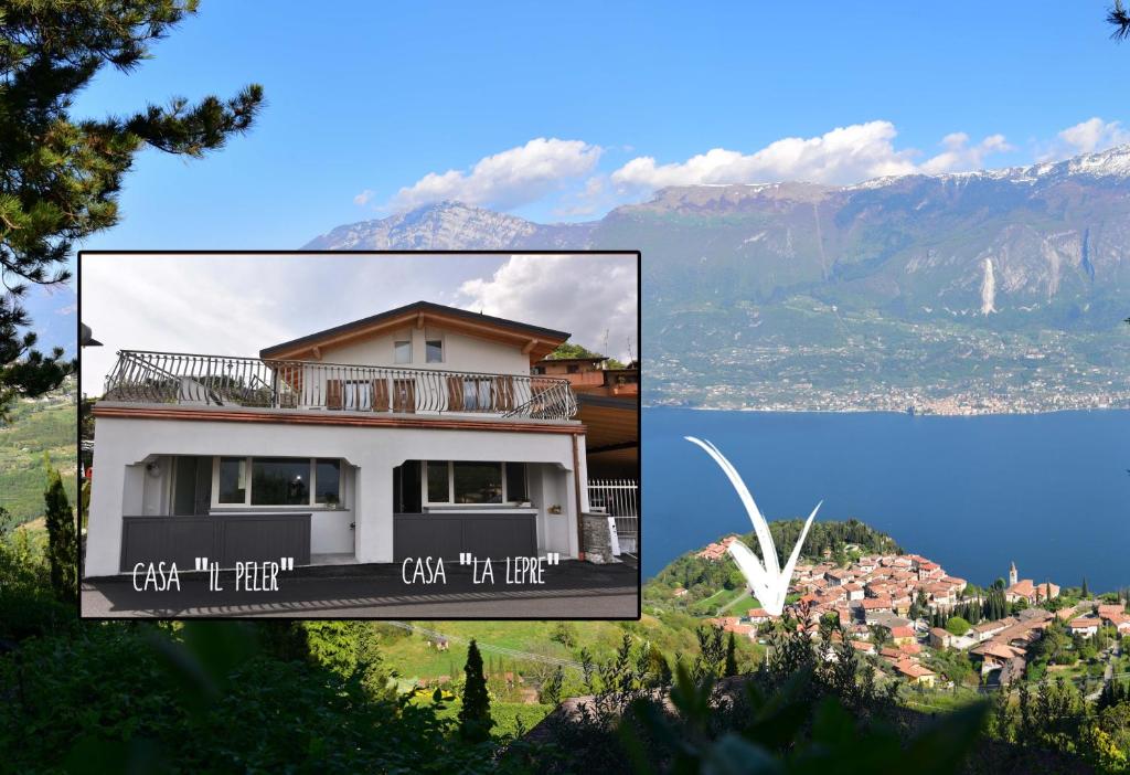 a picture of a house with mountains in the background at Appartamenti Fossato in Tremosine Sul Garda