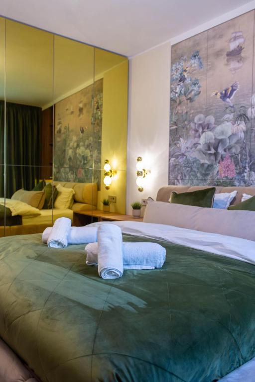 a bedroom with a large bed with towels on it at The Royal Palace Luxury Suite by Sattal in Bucharest