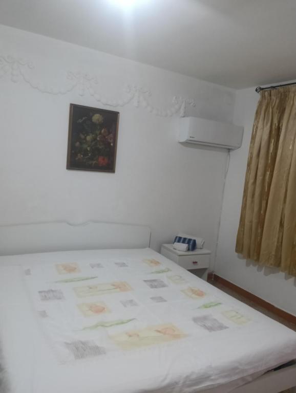 a bedroom with a bed with a picture on the wall at Mansarda arredata in Floridia