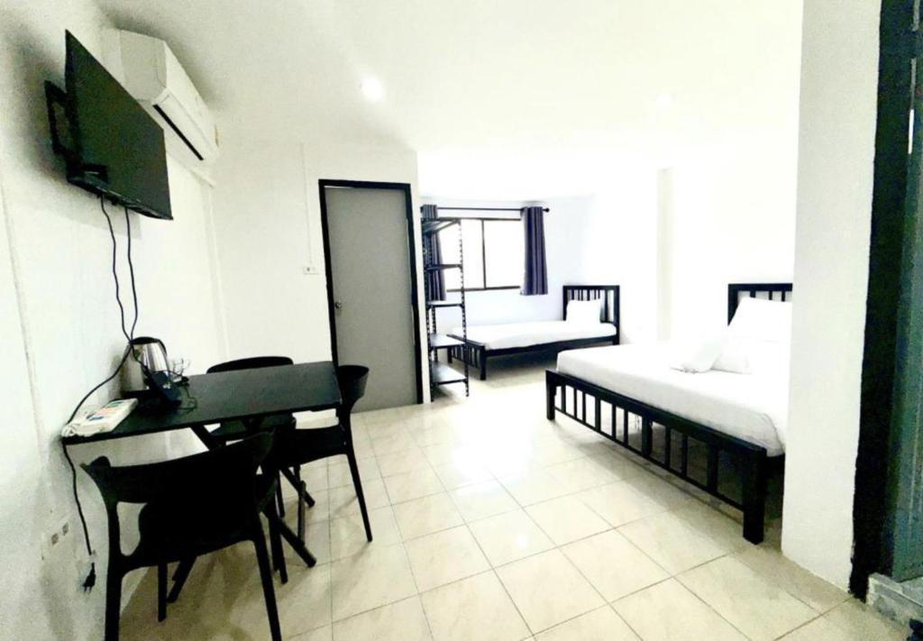 a room with a desk and a bed and a bed and a desk at Patong Canal Villa R312 in Patong Beach