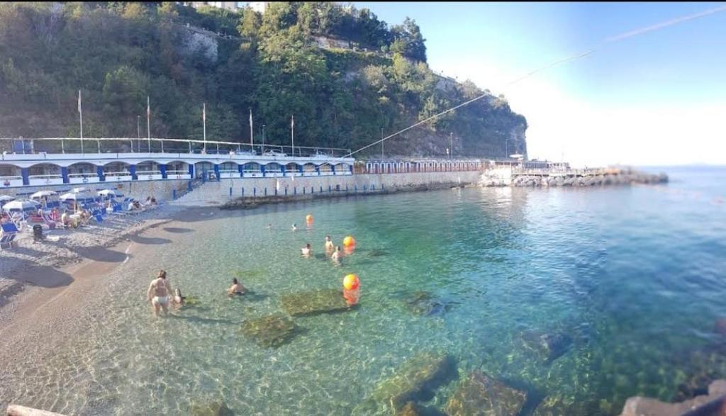 a group of people in the water at a beach at Casa Signorile in Pompei