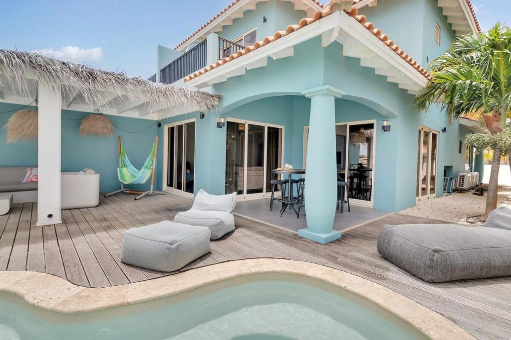 a villa with a swimming pool and a house at Casa Pimienta in Water Villas in Kralendijk
