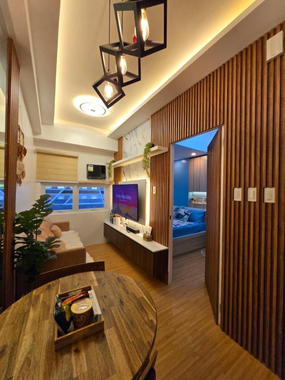 a living room with a couch and a table at Cozy place near pavilion mall and Sm starosa in Biñan