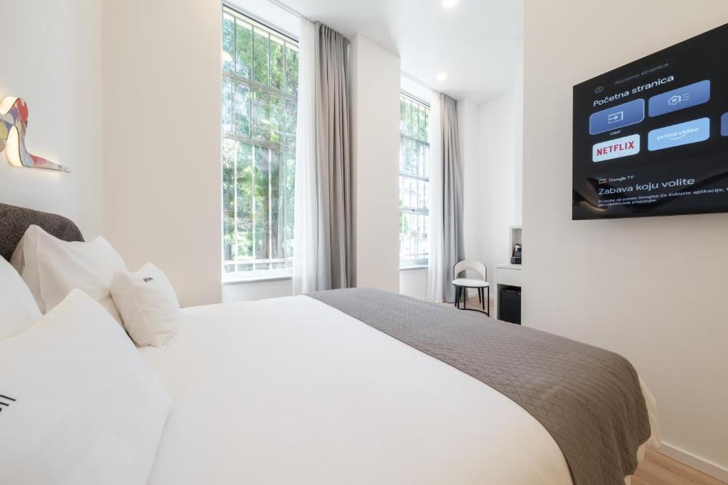 Postel nebo postele na pokoji v ubytování Hotel Eleven