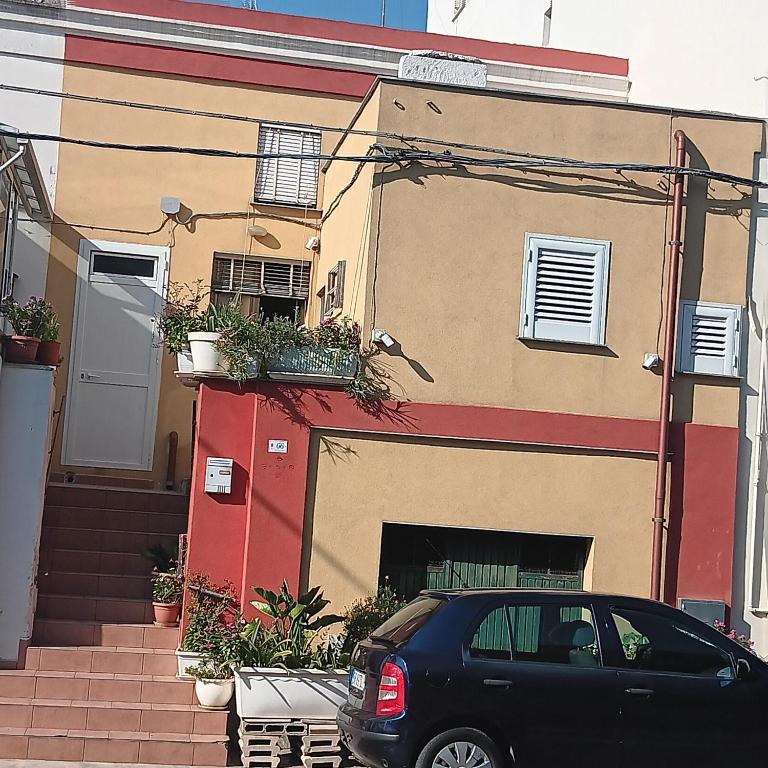 a black car parked in front of a house at Casa Nashi in Ugento