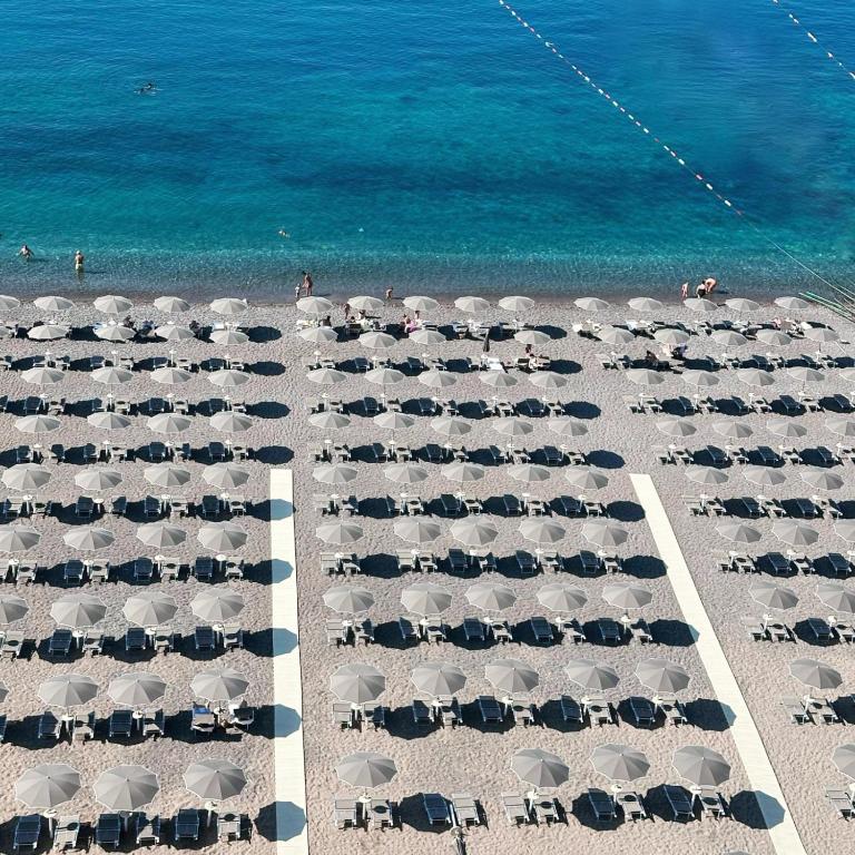 an overhead view of a beach with chairs and umbrellas at Sea Star Budva in Budva