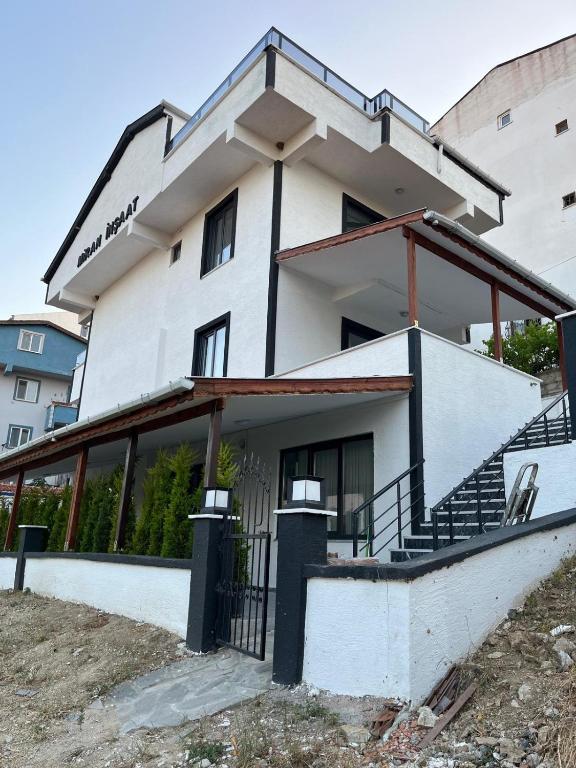 a white building with a staircase in front of it at Ege Naz Villa in Avşa Adası